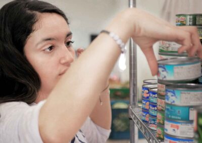 Young volunteer stocking groceries at the Arizona Kosher Pantry